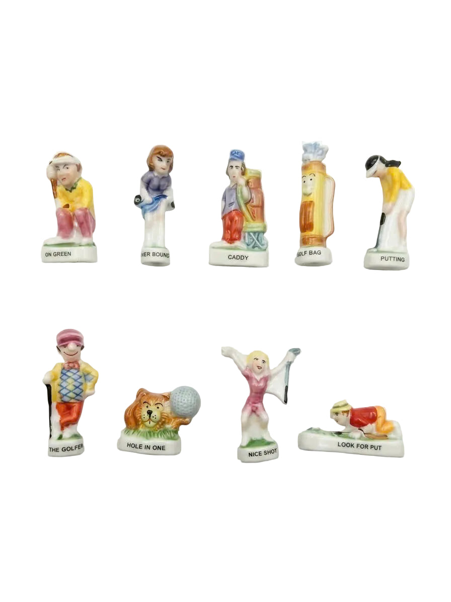 9 golf-themed porcelain fève figurines including On Green, Caddy, Hole in One, Nice Shot and Look for Putt characters, hand-painted