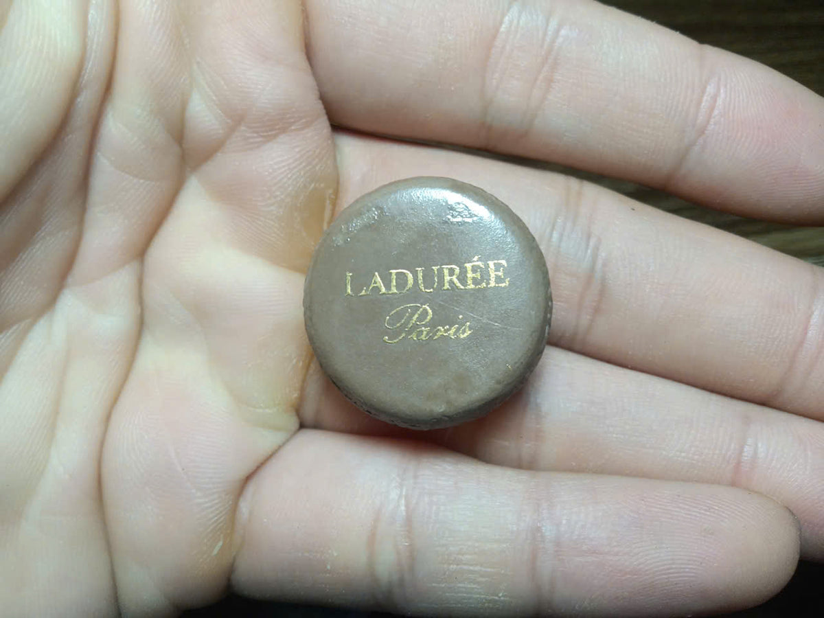 Vintage Ladurée fève – gold-toned dome top with engraved L monogram