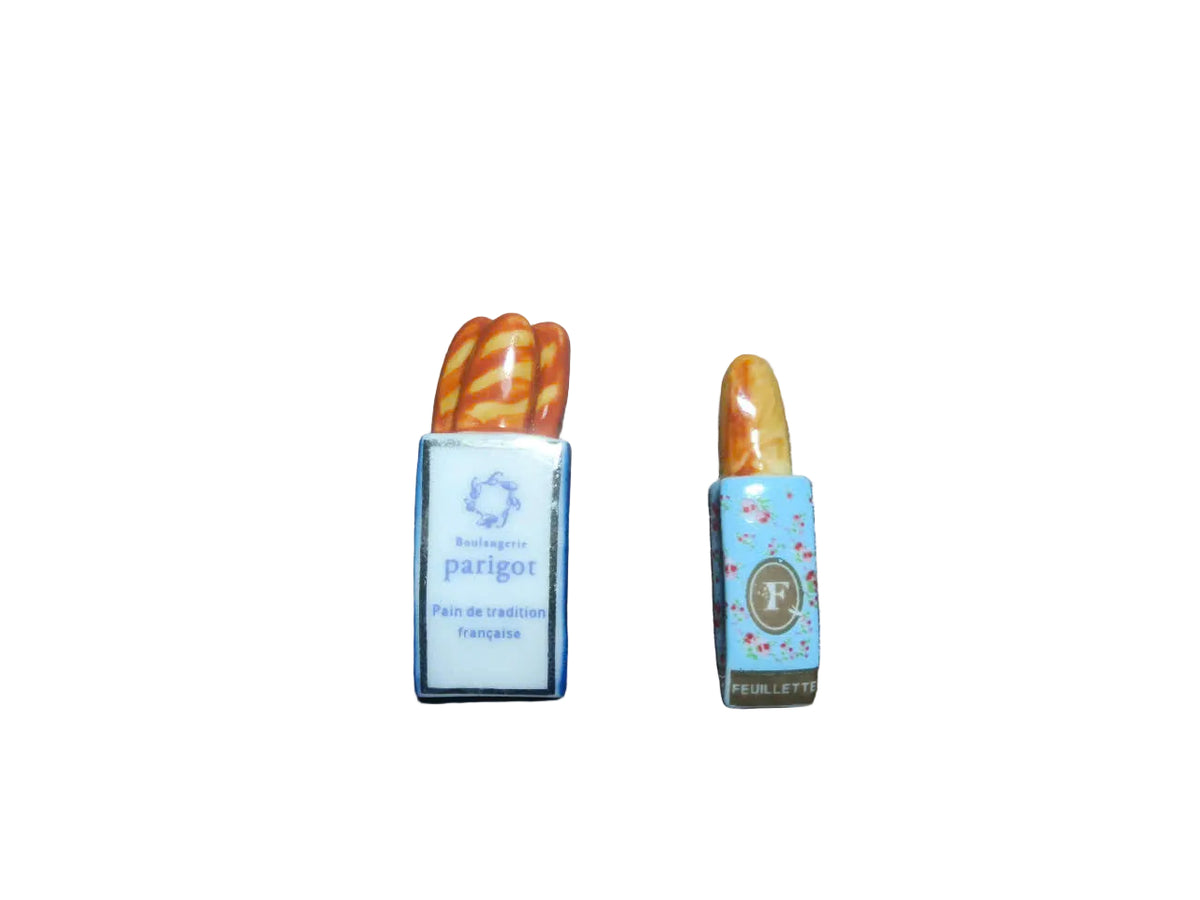 Two vintage French bakery fèves side by side – Boulangerie Parigot tresse and Feuillette baguette